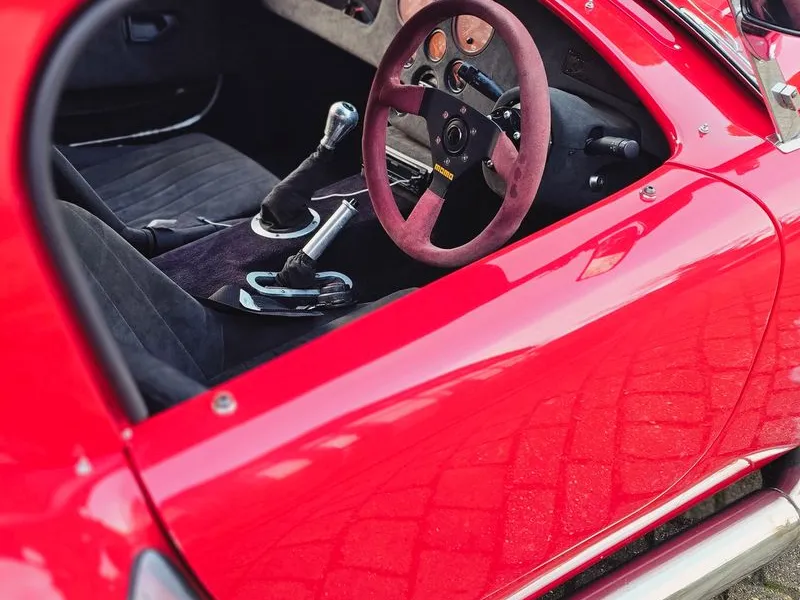 Red AC Cobra interior driver side with Momo steering wheel