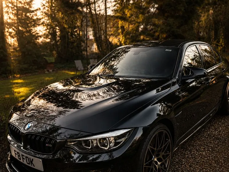 Black BMW M3 front three-quarter view