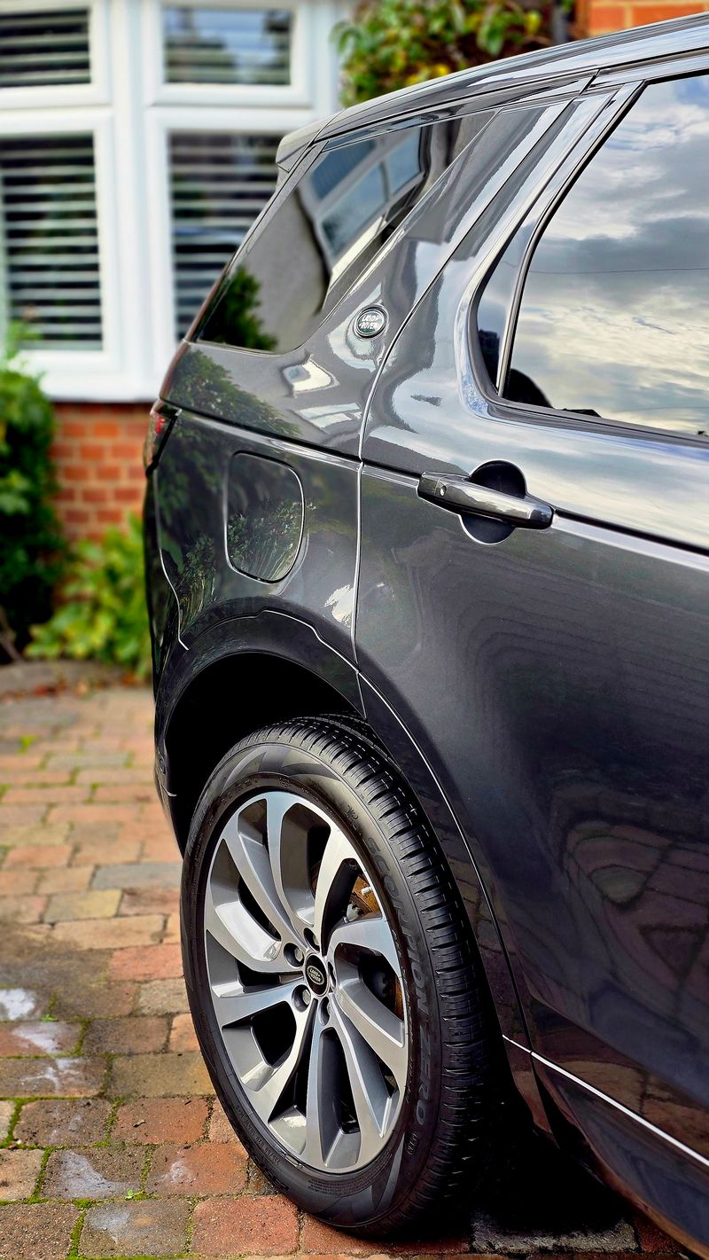 Glossy dark grey Land Rover exterior rear quarter view