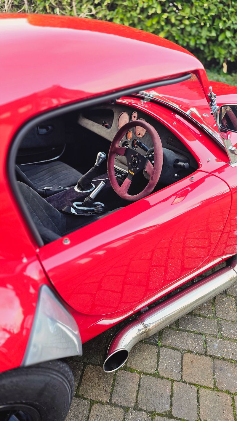 Red AC Cobra interior driver side with Momo steering wheel