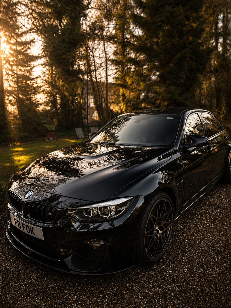 Black BMW M3 front three-quarter view